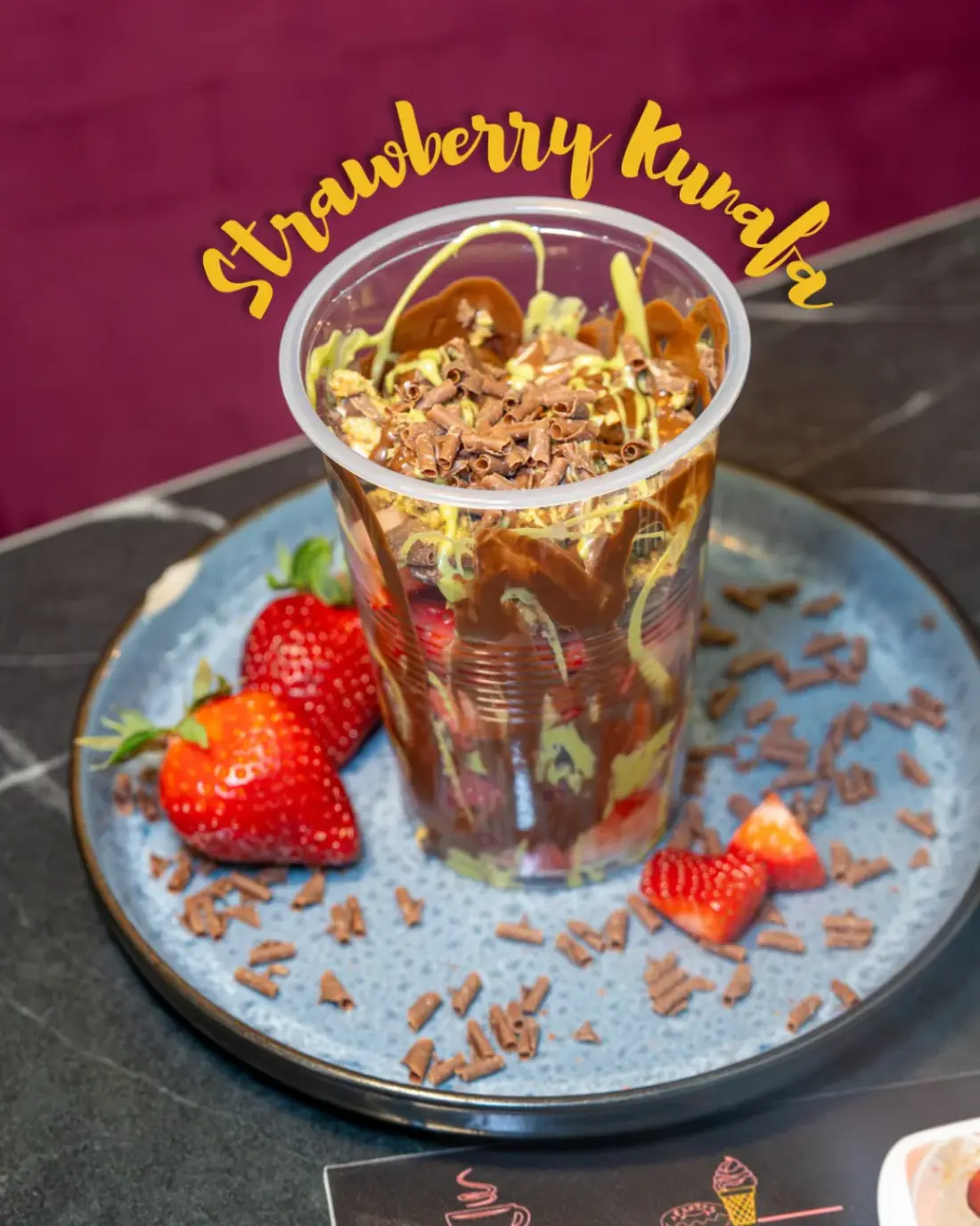 Strawberry kunafa cup topped with chocolate curls